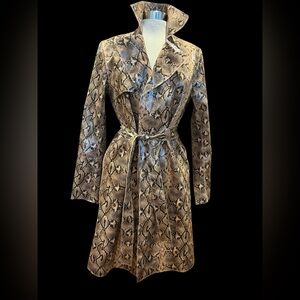 From Blank NYC comes this faux python belted trench coat